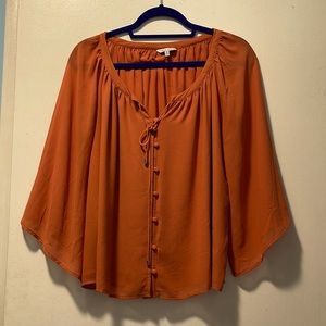 Beautiful, flutter sleeve blouse in a light rust color